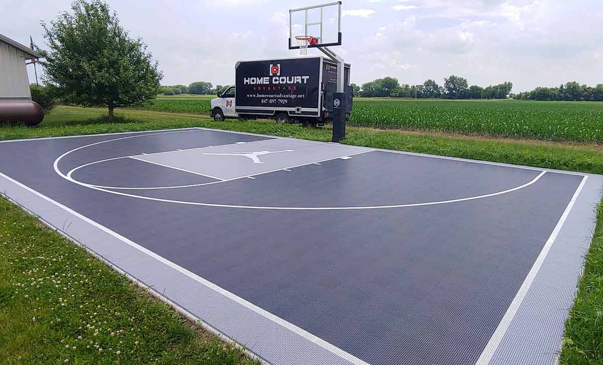 An outdoor basketball court at a residential home.