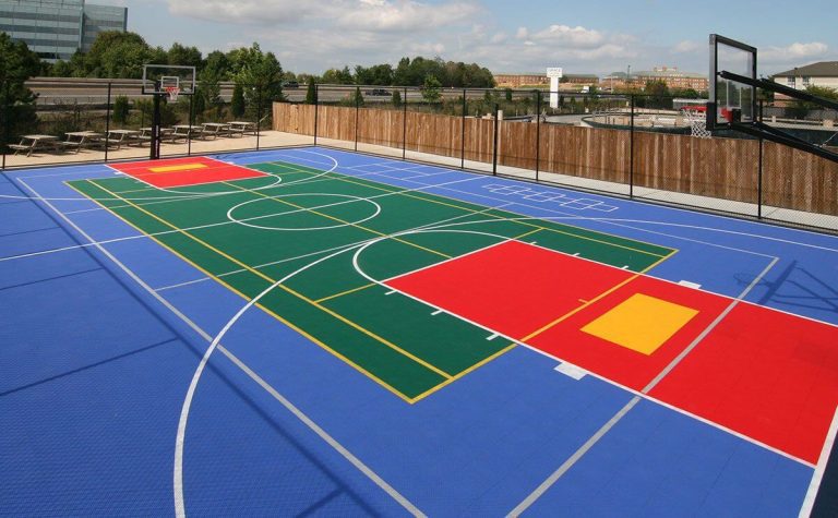 A basketball court with a blue and red surface.