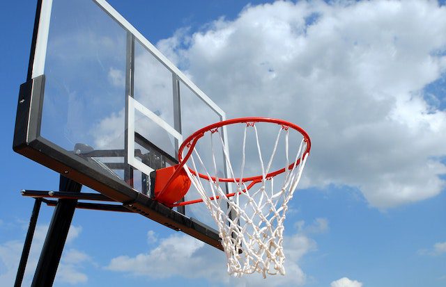 A basketball hoop against a blue sky.