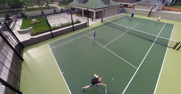 An aerial view of a tennis court in Florida with people playing on it.