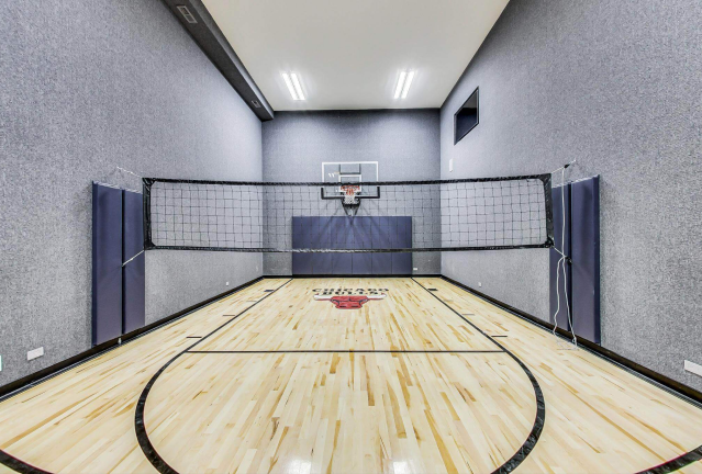 A home basketball court with hardwood floors.