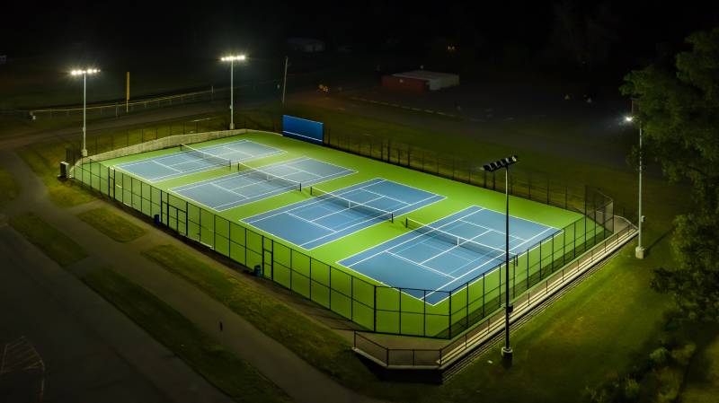 An aerial view of a tennis court at night in Florida.
