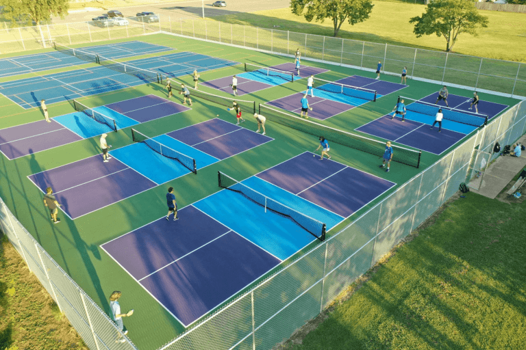 A group of people playing tennis on a tennis court while using diagram for layout planning.